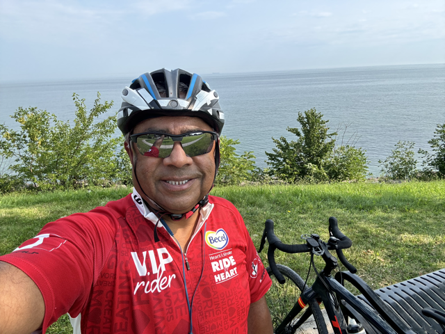 Cyclist resting on a bluff overlooking Lake Ontario