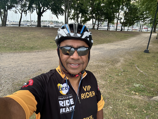 Cyclist in a park beside a marina before a morning ride